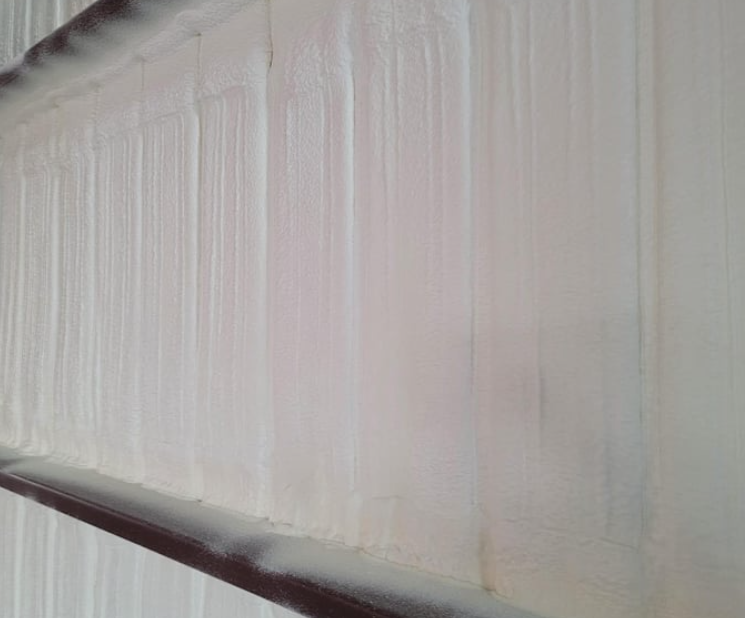 Closed cell spray foam insulation applied to a building