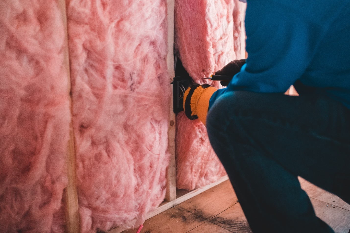 A professional works with wall insulation in Fort Worth, Texas